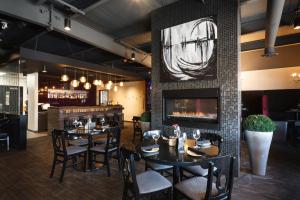 a restaurant with tables and chairs and a fireplace at Frantz Inn in Steinbach