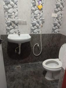 a bathroom with a toilet and a sink at Abi Homestay - with Luxury feel at Guduvanchery 