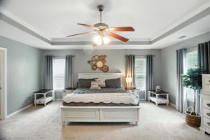 a bedroom with a bed and a ceiling fan at Lowcountry Luxury Near Palmetto Bluff home in Hardeeville