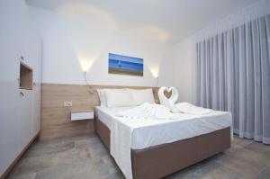 a bedroom with a bed with a swan on it at Corso Levante Luxury Suites in Petrovac na Moru