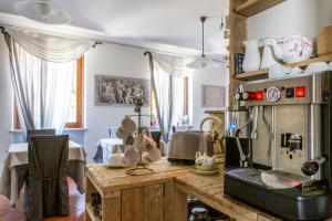 a kitchen with a wooden counter top with a microwave at Hotel Florence in Manerba del Garda +45 photos
