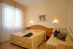 Posteľ alebo postele v izbe v ubytovaní Hotel Katy