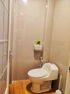 a bathroom with a toilet with a plant on it at Anymor Homestay in Komodo Labuan Bajo Airport