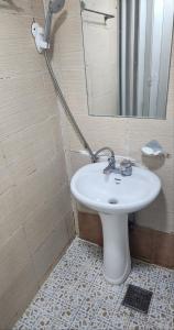 a bathroom with a white sink and a mirror at Time Stay in Busan