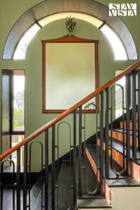 a staircase in a building with a framed picture on the wall at StayVista at Villa Harmony with Bonfire, Pool in Alibaug