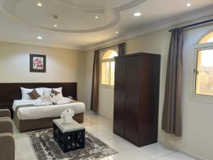 a bedroom with a bed and a cabinet in it at فندق ريست ان الربوة in Medina