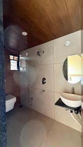 a bathroom with a sink and a toilet and a mirror at Neelkanth Resort in Devgarh +85 photos