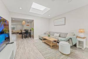 a living room with a couch and a table at Peaceful Home Near Beach & Disneyland in Huntington Beach