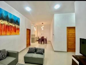 a living room with a couch and a tv at Gareka villa in Amed