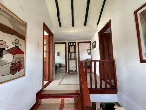 a hallway of a home with a wooden staircase at Casa Rosita Cerca a Plaza Mayor in Villa de Leyva +10 photos