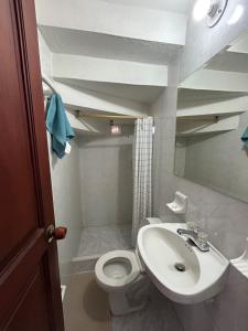 a small bathroom with a toilet and a sink at Casa Rosita Cerca a Plaza Mayor in Villa de Leyva
