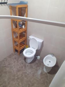 a bathroom with a toilet and a sink at Limones in Mariano Moreno