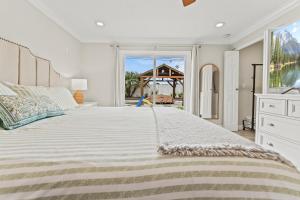 a bedroom with a large bed with a large window at Peaceful Home Near Beach & Disneyland in Huntington Beach +73 photos