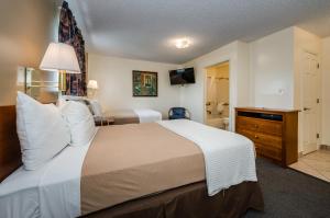 A bed or beds in a room at Tampa Bay Extended Stay Hotel