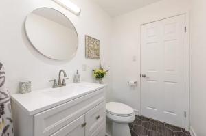 a white bathroom with a sink and a mirror at Central San Diego 2 BED Condo in San Diego +9 photos