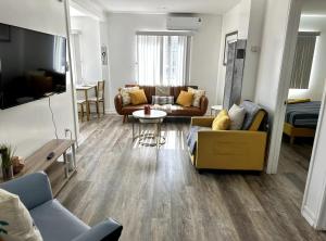 a living room with a couch and a table at Central San Diego 2 BED Condo in San Diego