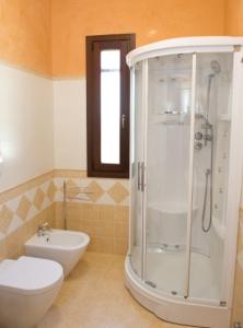 a bathroom with a shower and a toilet and a sink at I Due Pini in Sogliano Cavour +33 photos