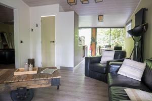 a living room with a couch and a coffee table at Corgi-Flowerhuisje in Lanaken