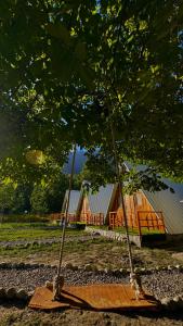 a couple of swings in front of a house at Fortyard Cottages Hunza in Karimabad Hunza