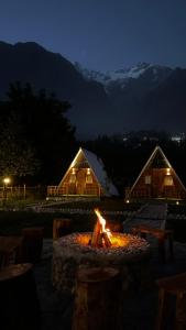 a fire pit in front of a lodge at night at Fortyard Cottages Hunza in Karimabad Hunza +2 photos