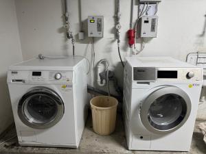 a laundry room with a washer and a washing machine at WuP Living Apartment am Stadtwald TG Parkplatz in Augsburg +2 photos