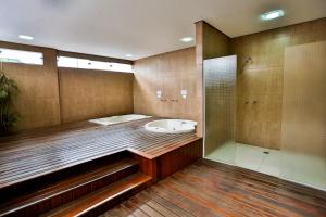 a bathroom with a shower and a bath tub at Monte Serrat Hotel in Santos +50 photos