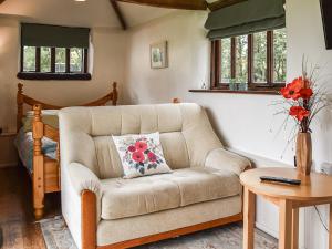 a living room with a couch and a table at The Retreat - Uk48231 in Tibenham