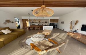 a living room with a couch and a table at Julim Aura - Best Agung View in Amed