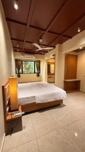 a bedroom with a large bed in a room at Neelkanth Resort in Devgarh