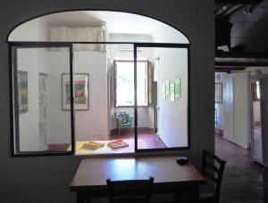 a dining room with a table and a large window at Casa Sophie in Florence