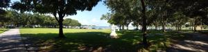 a park with trees and the water in the background at The Birchwood in St. Petersburg