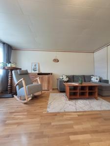 a living room with two couches and a coffee table at 3-room homey apartment in Kärdla in Kärdla +9 photos