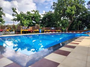 a large swimming pool with blue water at Ryka Tranquil Resort in Guwahati