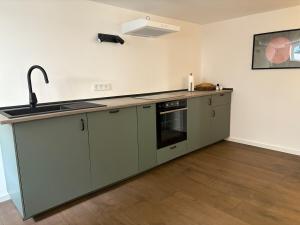 a kitchen with a sink and a counter top at Waldblick am Rhein - Natur & Citynah - in Bonn +9 photos