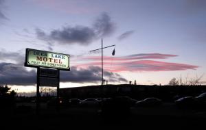 a sign for a motel under a cloudy sky at Deer Lake Motel in Deer Lake