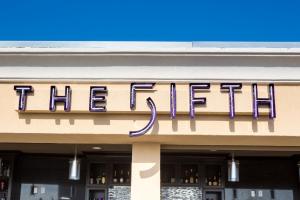 a sign on the side of a store at Grand Legacy At The Park in Anaheim