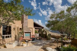 a resort with a picnic table and a building at Saguaro Ridge by Fieldtrip Boulder Estate w Mtn Views Hot Tub Soaking Pool Yoga Deck in Yucca Valley