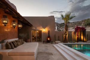 a living room with a pool and a house at Saguaro Ridge by Fieldtrip Boulder Estate w Mtn Views Hot Tub Soaking Pool Yoga Deck in Yucca Valley