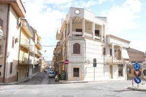 a building with a clock on the side of a street at Rosemary Home in Barrafranca +12 photos