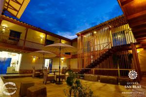a building with a balcony and a table with umbrellas at Quinta San Blas by Ananay Hotels in Cusco