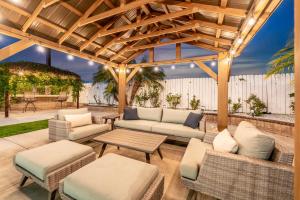 a patio with couches and a table and chairs at Peaceful Home Near Beach & Disneyland in Huntington Beach