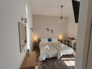 Ένα ή περισσότερα κρεβάτια σε δωμάτιο στο Ostria Rooms 