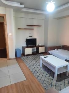a living room with a couch and a coffee table at Siesta Apart Otel İzmir in İzmir