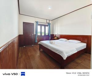 a bedroom with a large bed with white sheets at DONDET Vixay Sunset And River View in Don Det