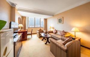 a living room with a couch and a table at Kunming Hotel in Kunming