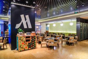 a dining room with tables and chairs in a restaurant at Beijing Marriott Hotel Northeast in Beijing