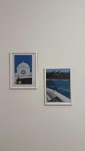 two framed photographs hanging on a white wall at Apartmani Grebastica in Grebaštica