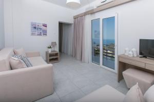 a living room with a couch and a television at 12 Olympian Gods in Platamonas