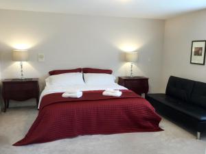 a bedroom with a bed with two towels on it at Vancouver Pacific Guest House in Richmond