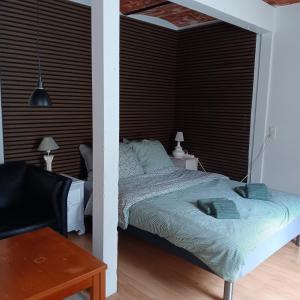 a bedroom with a bed with a black headboard at Bøelgaarden in Gørding